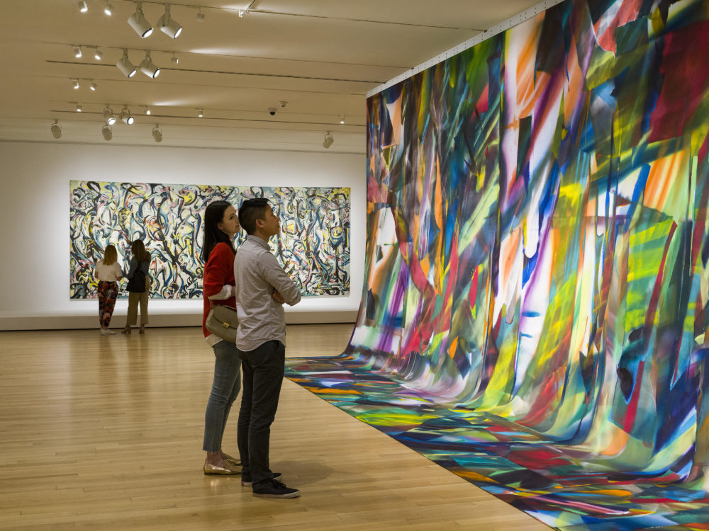 Visitors look at Katharine Grosse's painting. You could see Jackson Pollock's &quot;Mural&quot; in the background. (Courtesy Museum of Fine Arts, Boston)