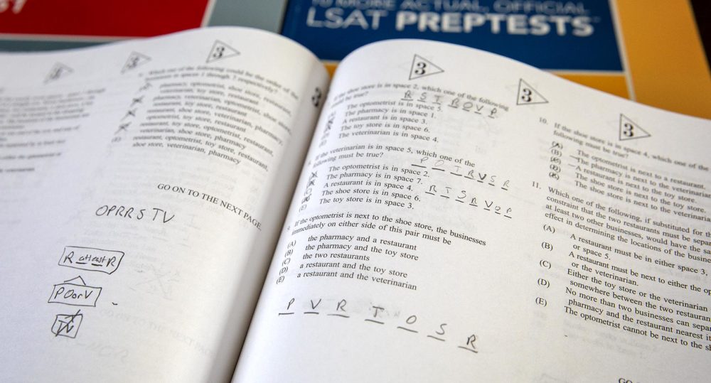 Logic game questions in an LSAT prep test book (Robin Lubbock/WBUR)
