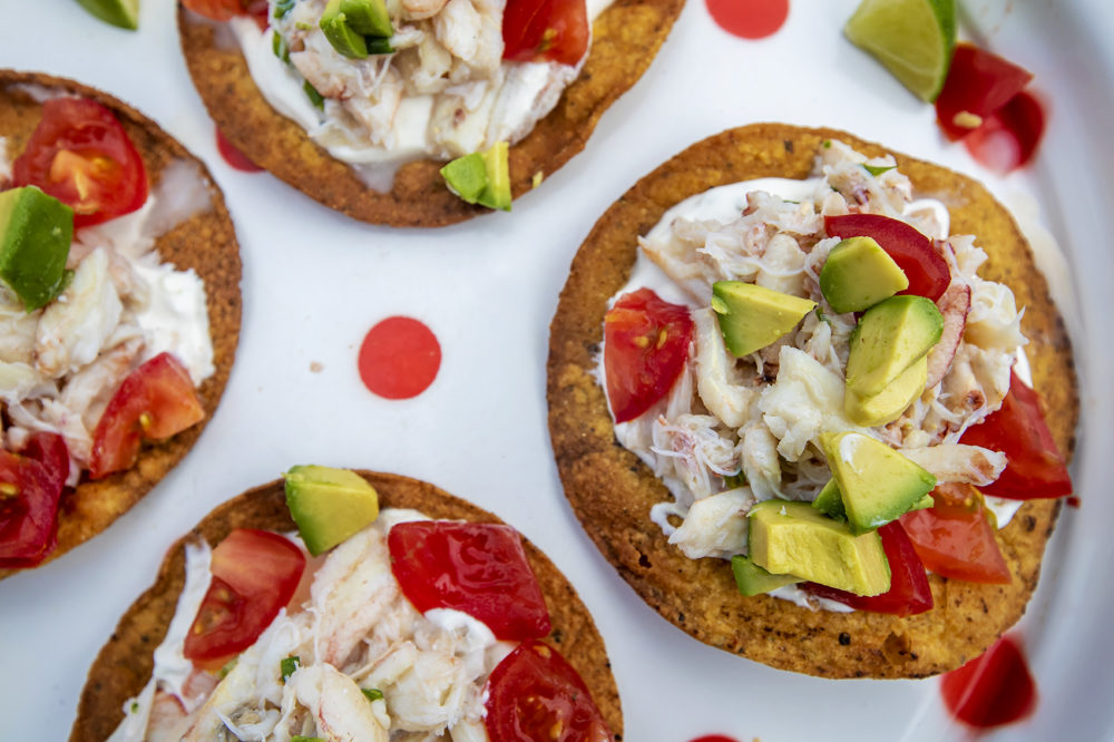 Tostados — fried tortillas— are perfect when made with blue corn tortillas and topped with blue crab, red salsa and white sour cream. (Jesse Costa/WBUR)