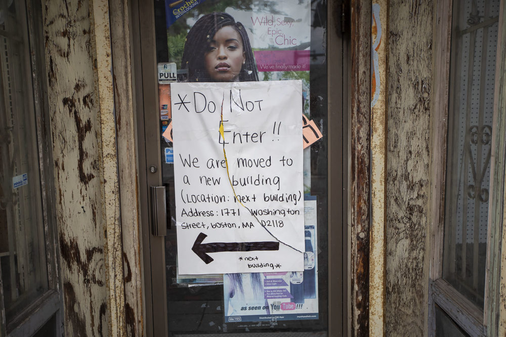 A sign indicates the last remaining tenant in the Alexandra Hotel building has moved. (Jesse Costa/WBUR)