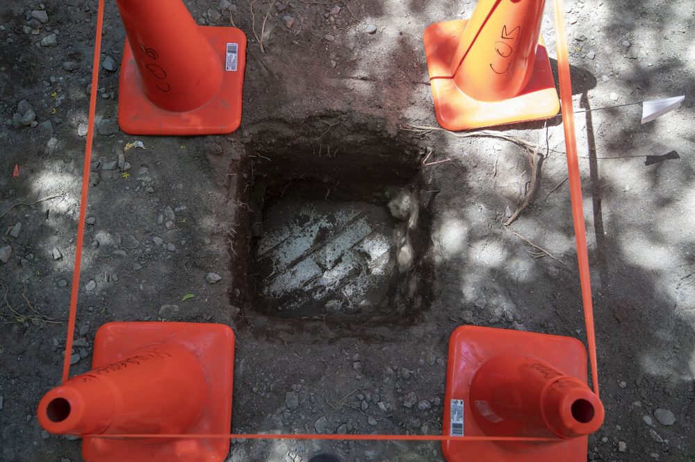A white-painted brick surface was found in one of the test pits in the rear of the site at 6 Hudson St. in Boston’s Chinatown. (Jesse Costa/WBUR)