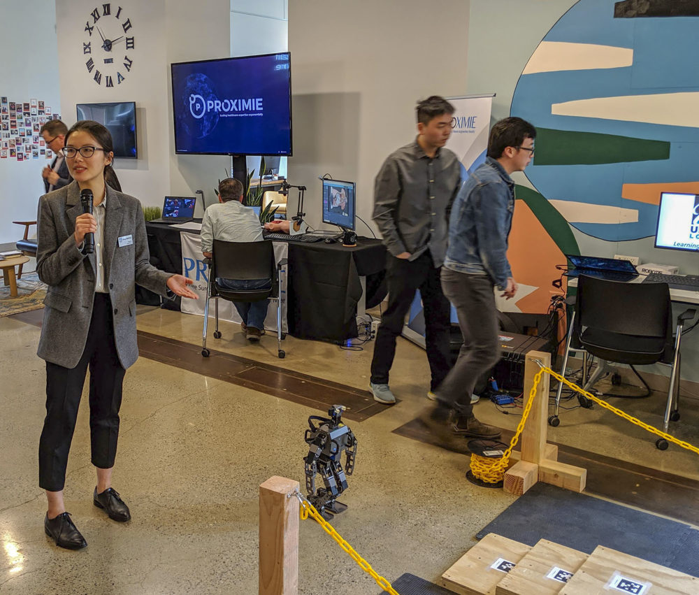 UMass Lowell mechanical engineering professor Yan Gu demonstrates a robot on a 5G cellular network at the Verizon Alley in Cambridge. (Courtesy of Verizon)