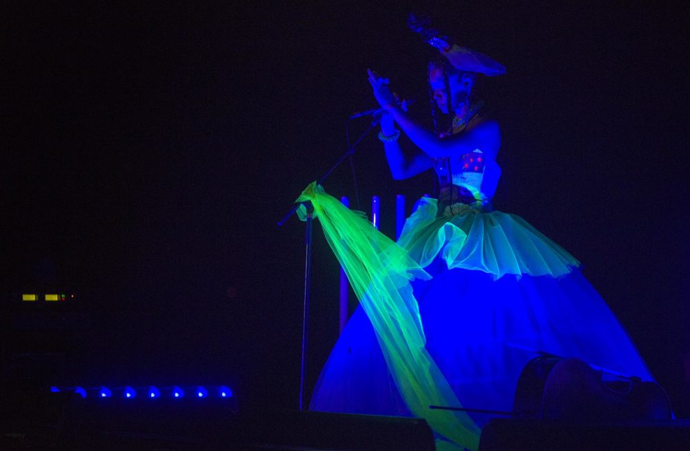 Kelsey Lu performs on a stage by the beach at Long Point as the balloon begins to inflate. (Robin Lubbock/WBUR)