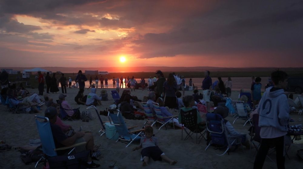 People gathered on the sand at sunset for the New Horizon event at Long Point in Martha's Vineyard. (Robin Lubbock/WBUR)