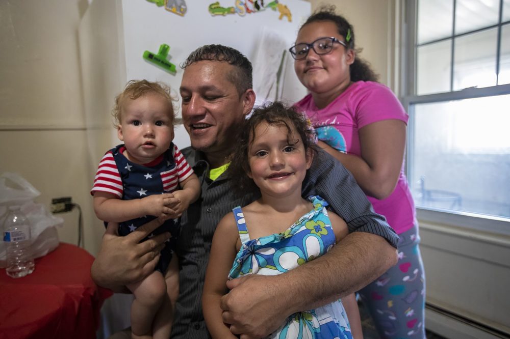 Gilberto Pereira Brito with his three children. From left to right, Junior Pereira Brito, 1, Gilberto Pereira Brito, Taliyah Pereira Brito, 4, and Tatyana Pereira Brito,10. (Jesse Costa/WBUR)