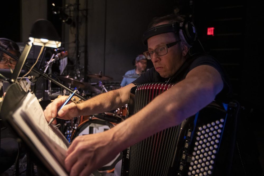 Peter Bufano makes a few changes to the score after some alterations to the act have been discussed. (Jesse Costa/WBUR)