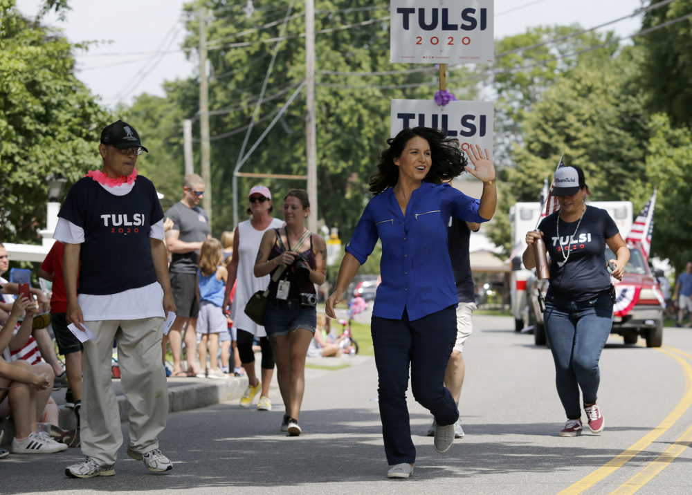 Democratic presidential candidate U.S. Rep. Tulsi Gabbard, D-Hawaii, waves as she runs along the route during the Fourth of July Parade in Amherst, N.H.. (Mary Schwalm/AP)