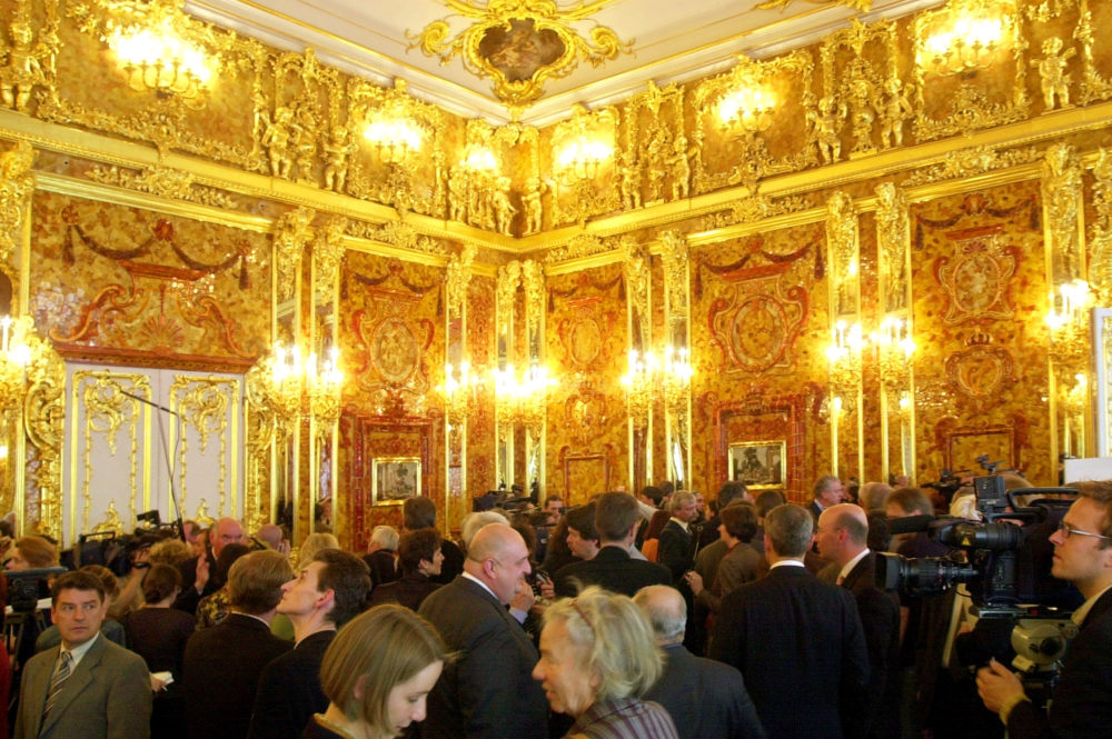 Visitors look at the Amber Room in the Catherine Palace near St. Petersburg, Russia, as the restored chamber was presented to reporters. (AP Photo/ Dmitry Lovetsky)