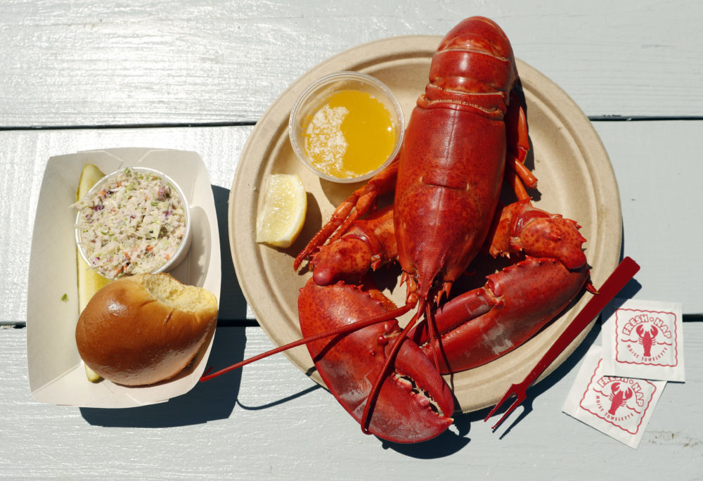 A cooked lobster is served on a picnic table at McLoon's Lobster Shack in Spruce Head, Maine. (Robert F. Bukaty/AP File Photo)