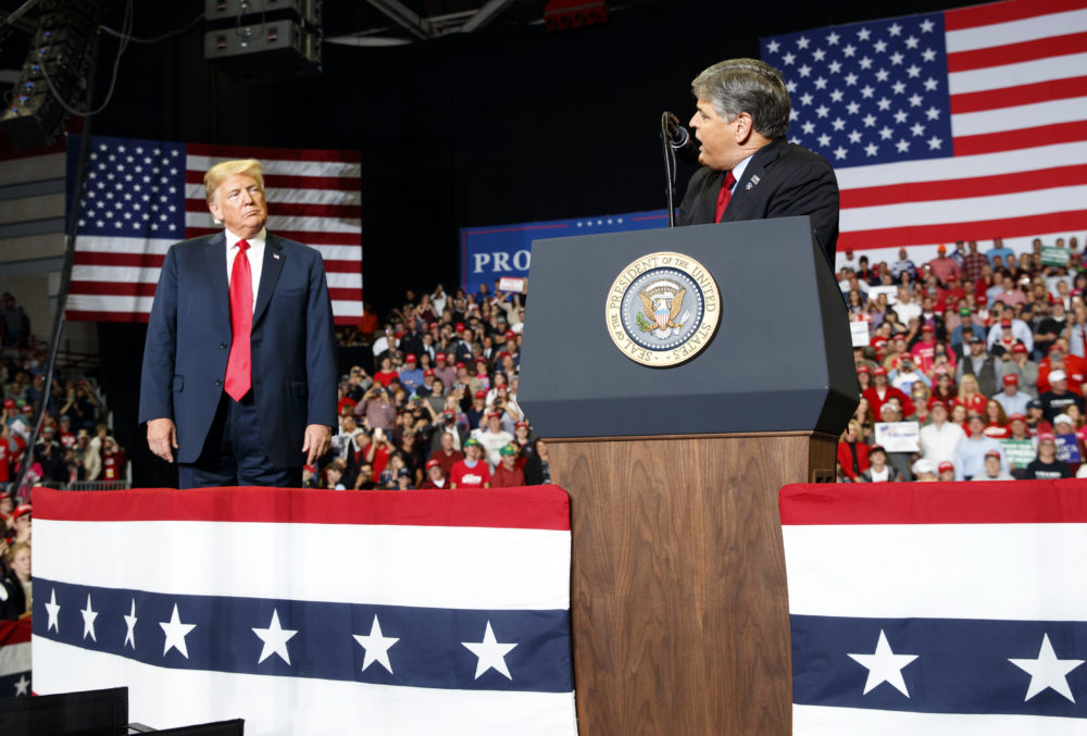 President Donald Trump listens to Fox News' Sean Hannity speak during a rally at Show Me Center, Monday, Nov. 5, 2018, in Cape Girardeau, Mo. (Carolyn Kaster/AP)