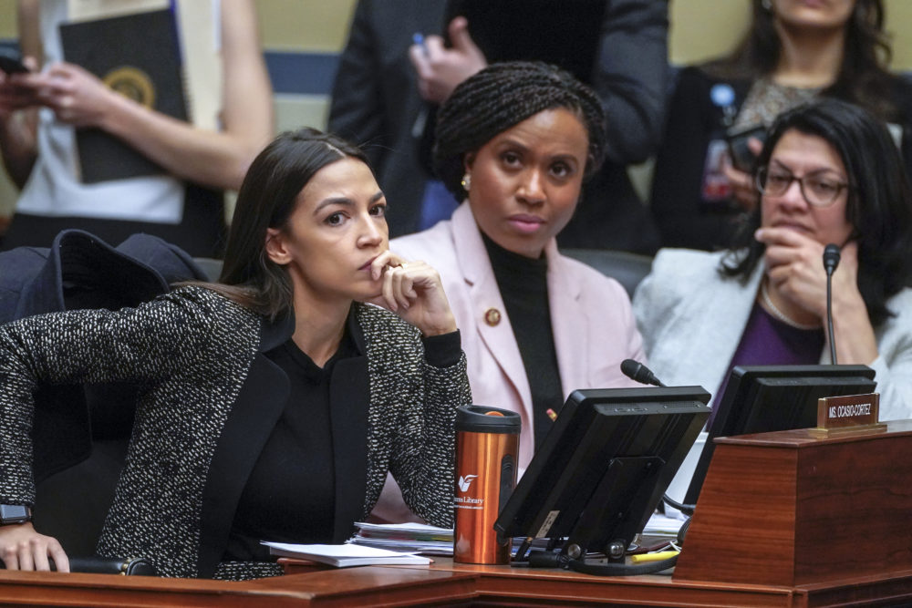 Rep. Alexandria Ocasio-Cortez, D-N.Y., left, joined by Rep. Ayanna Pressley, D-Mass., and Rep. Rashida Tlaib, D-Mich., listens during a House Oversight and Reform Committee meeting, on Capitol Hill in Washington (J. Scott Applewhite/AP)