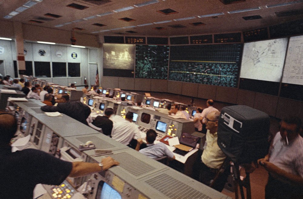 NASA mission control personnel watch the moonwalk by Apollo 11 astronauts, on July 21, 1969, in Houston. (NASA via AP)