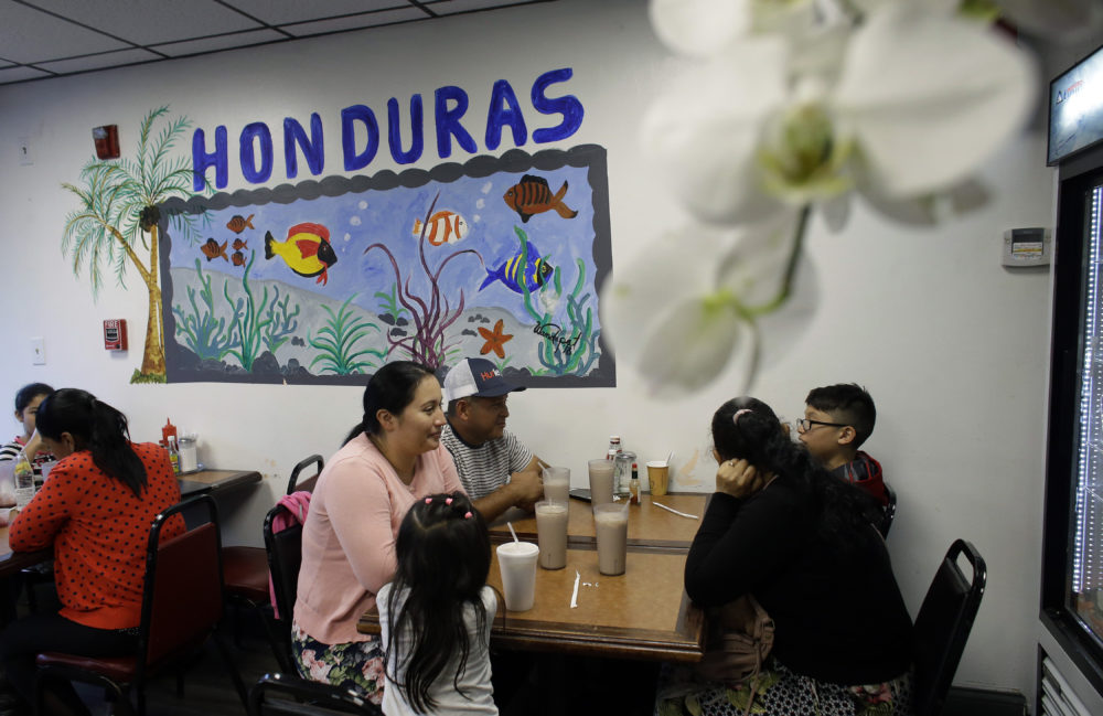 Diners eat in a Honduran-style restaurant in Chelsea, Mass. A recent study by the Pew Research Center shows the number of Central Americans in the United States increased over the last decade. Chelsea has exemplified that trend with a population that is more than 60% Latino. (Steven Senne/AP)
