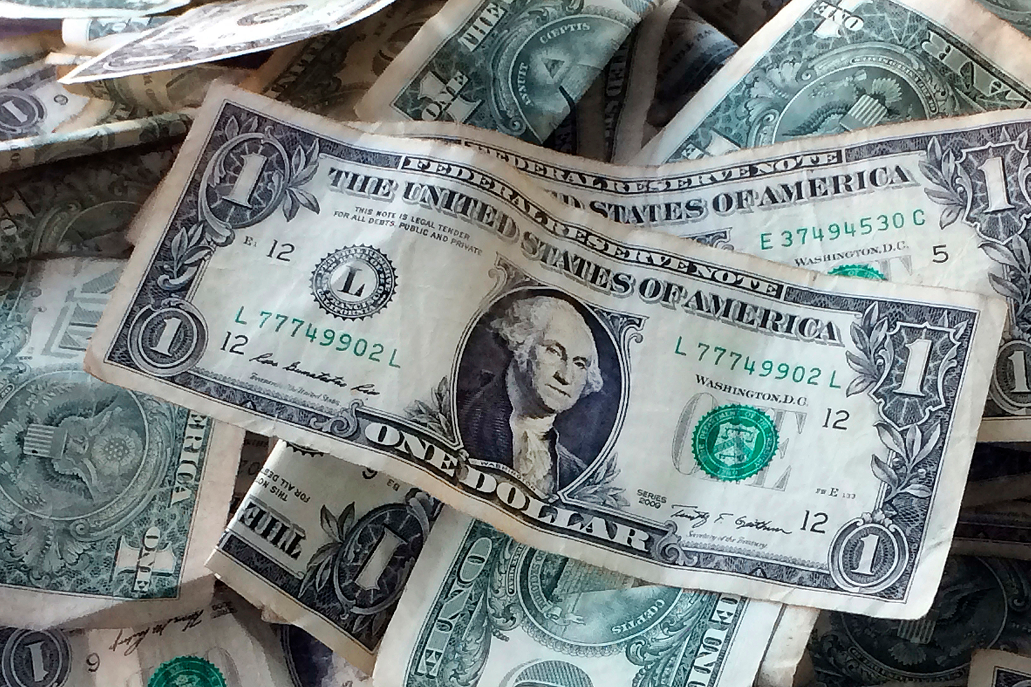 The $15 dollar minimum wage could boost pay for 17 million but some workers might lose their jobs, says newer reports. (Mark Lennihan, AP Photo)