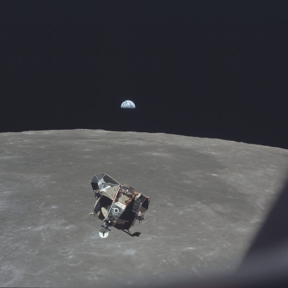In this July 21, 1969 photo, the Apollo 11 Lunar Module ascent stage, carrying astronauts Neil Armstrong and Buzz Aldrin, approaches the Command and Service Modules for docking in lunar orbit. In the background the Earth rises above the lunar horizon. (Michael Collins/NASA via AP)