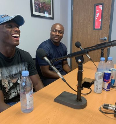 Derrick Etienne Jr. and Derrick Etienne Sr. laughing during the interview. (Arlo Moore-Bloom/WBUR)