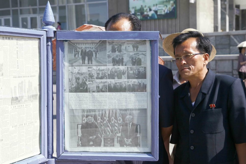 People are looking at the news that Kim Jong Un had a historic meeting with President Donald Trump at Panmunjom at the Mirae scientists street in Pyongyang, DPRK, on Monday, July 1st, 2019. (Jon Chol Jin/AP)