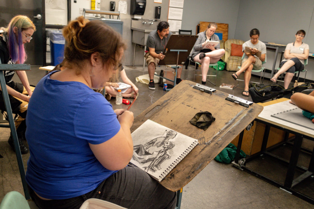 Artists draw during a figure class. (Courtesy Mel Isidor)