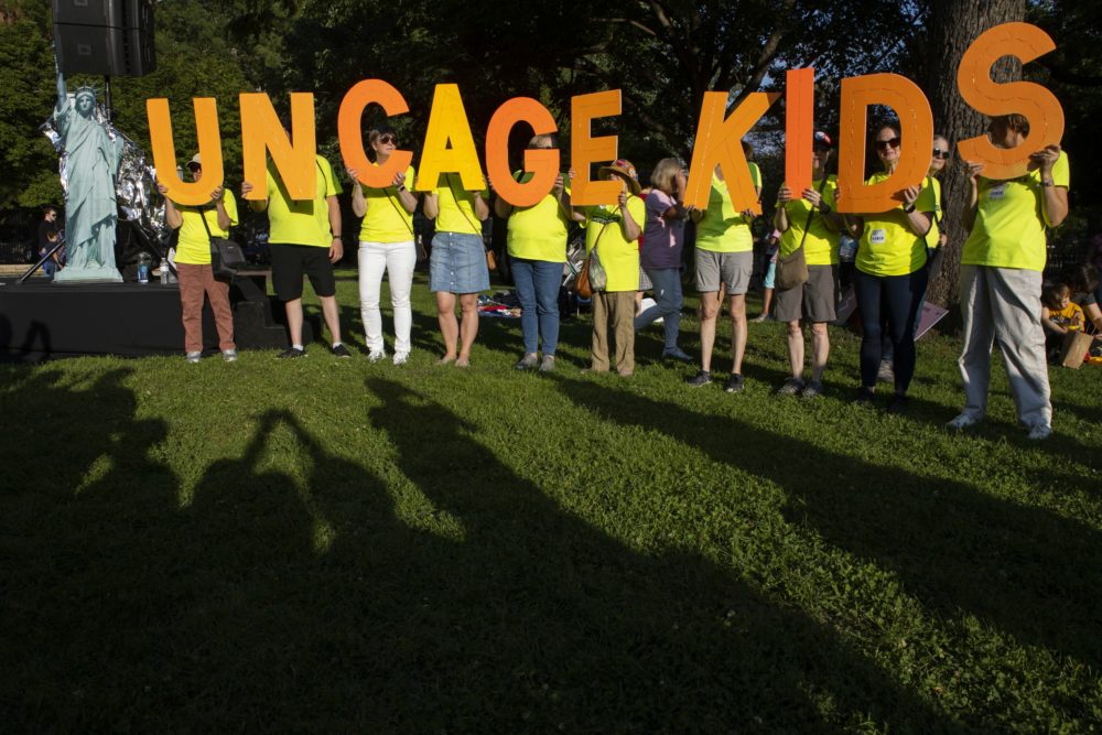 Protesters hold up a sign ready ‘uncage kids’ during a rally near the White House in Washington, on Friday, July 12, 2019. (Jon Elswick/AP)