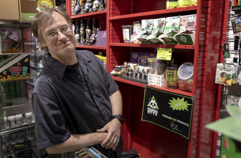 Donovan Bartish, assistant store manager at Shop Therapy in Northampton, stands by on-sale CBD edibles. (Robin Lubbock/WBUR)
