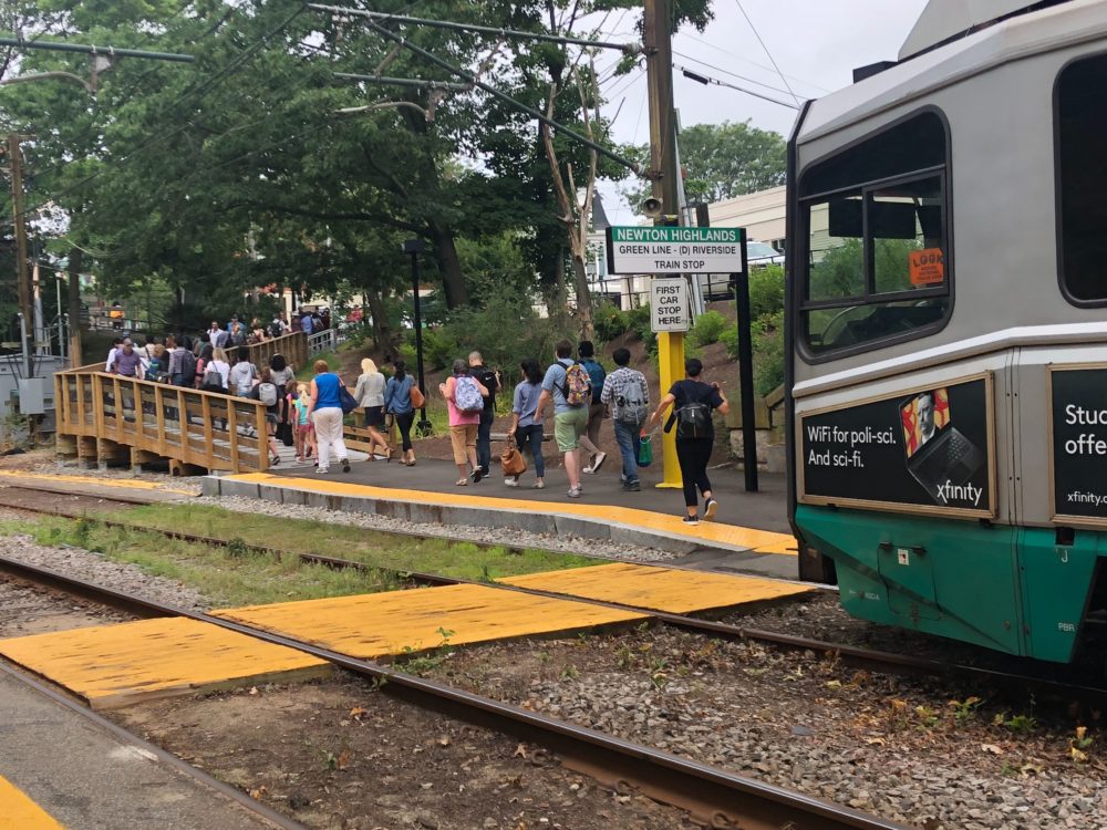 Green Line passengers at the Newton Highlands stop head for shuttle buses after a train on the D branch derailed earlier Wednesday morning. (Chris Lisinski/SHNS)
