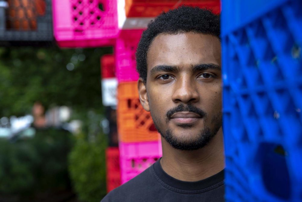 Artist Shaka Dendy stands in front of his completed public sculpture, &quot;Gestures of Incompleteness,&quot; in front of the Boston Center for the Arts in the South End. (Robin Lubbock/WBUR)