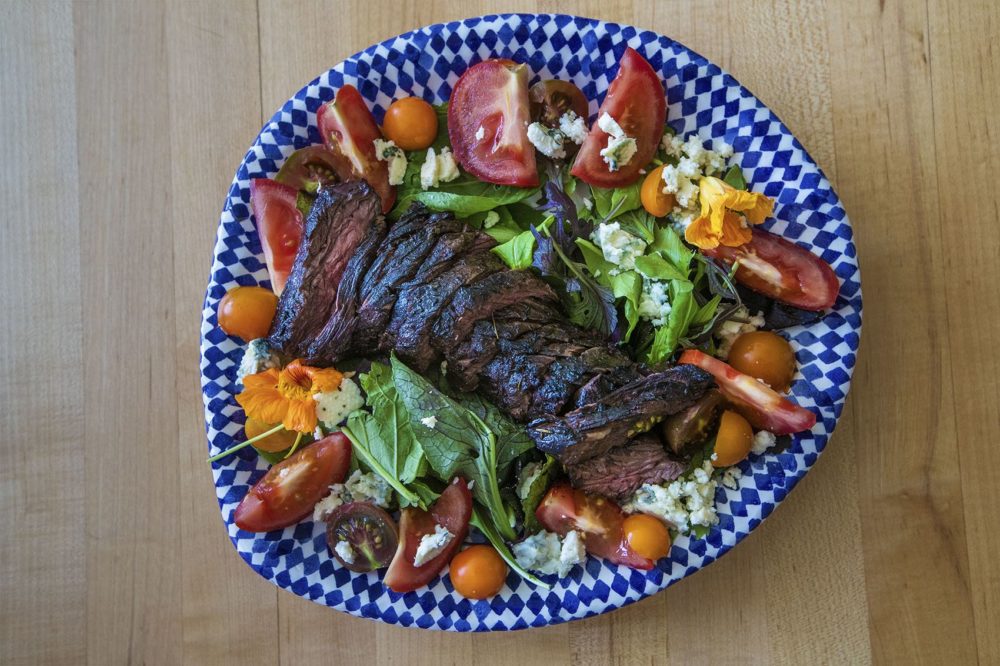 Chef Kathy Gunst's grilled steak salad with blue cheese, tomatoes, and greens. (Jesse Costa/WBUR)