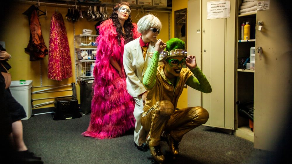 Holly Bourdon, Rachel Wirtz and Mitchell Todd pause for a moment before running down the stairs to greet their audience. (OJ Slaughter for WBUR)