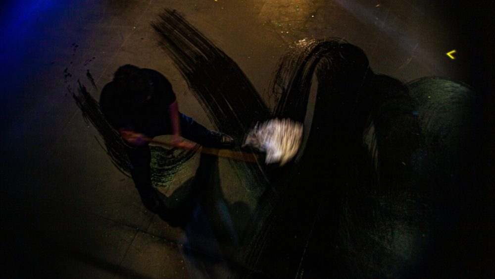 Justin Paice mops the dance floor before the show. (OJ Slaughter)