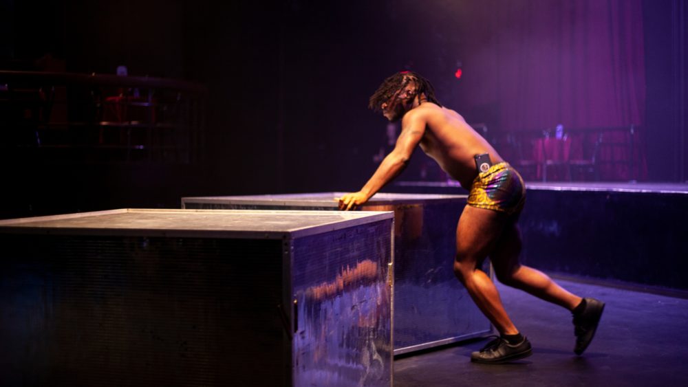 Brian Washburn, who performs as the fairy Cob Web, gets platforms in place for the evening's show. (OJ Slaughter for WBUR)