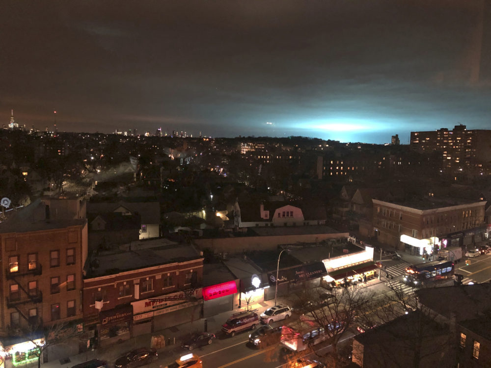 In this 2018 photo, the sky above a Con Edison facility in Queens is illuminated with a pulsing blue light after a blast at an electrical substation. (Barbara Woike/AP)