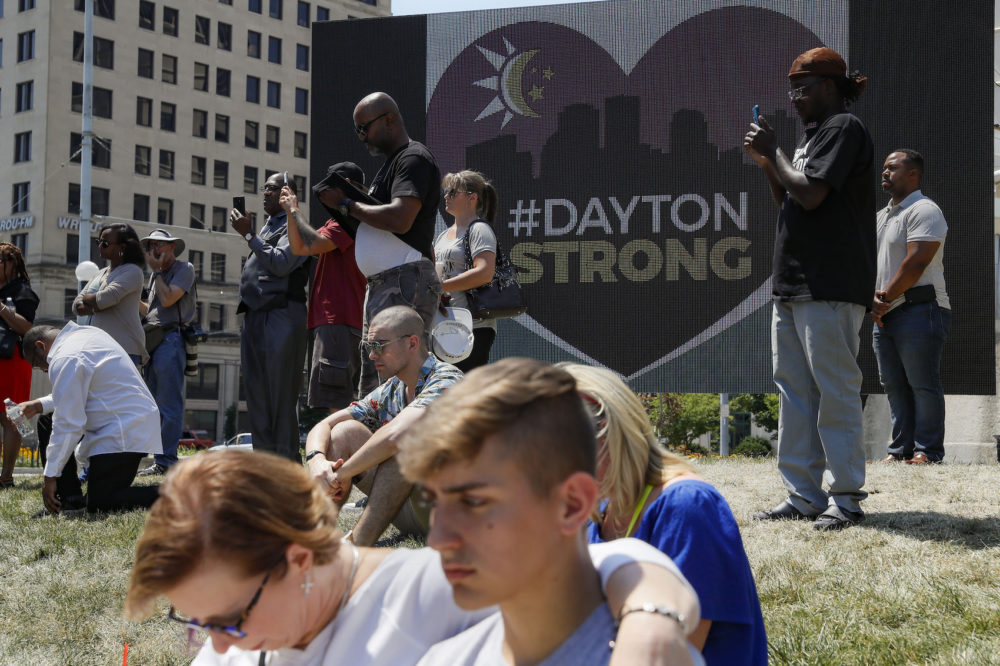 Mourners gather at a vigil following a nearby mass shooting, Sunday, Aug. 4, 2019, in Dayton, Ohio. Multiple people in Ohio were killed in the second mass shooting in the U.S. in less than 24 hours, and the suspected shooter is also deceased, police said. (John Minchillo/AP)
