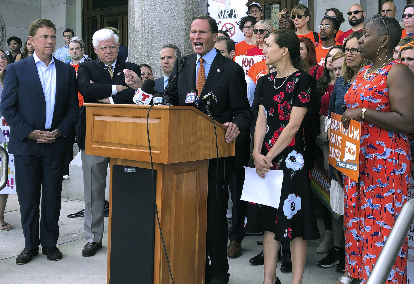 Senator Richard Blumenthal, center, speaks Monday, Aug. 5, 2019, outside the Capitol in Hartford, Conn., surrounded by Connecticut Gov. Ned Lamont, left, U.S. Rep. John Larson, second from left, Lt. Gov. Susan Bysiewicz, second from right, and state Rep. Robyn Porter, D-New Haven, right. The political delegation and gun safety groups rallied to urge the U.S. Senate to return immediately to Washington and follow the state's lead in passing stricter gun laws. (Susan Haigh/AP)