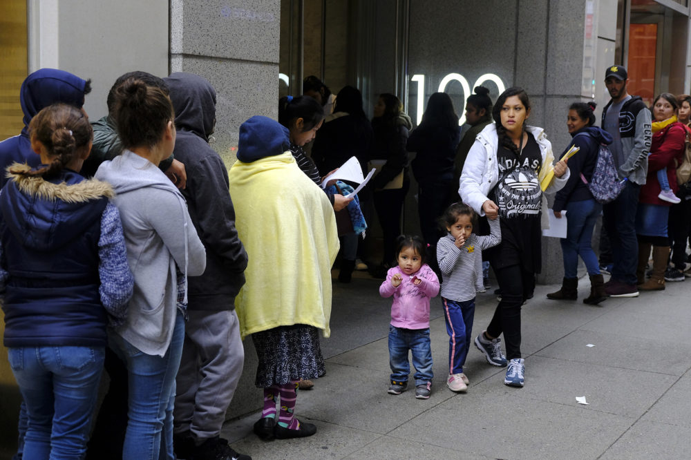 In this Jan. 31, 2019, file photo, hundreds of people overflow onto the sidewalk in a line snaking around the block outside a U.S. immigration office with numerous courtrooms in San Francisco. (Eric Risberg, File/AP)