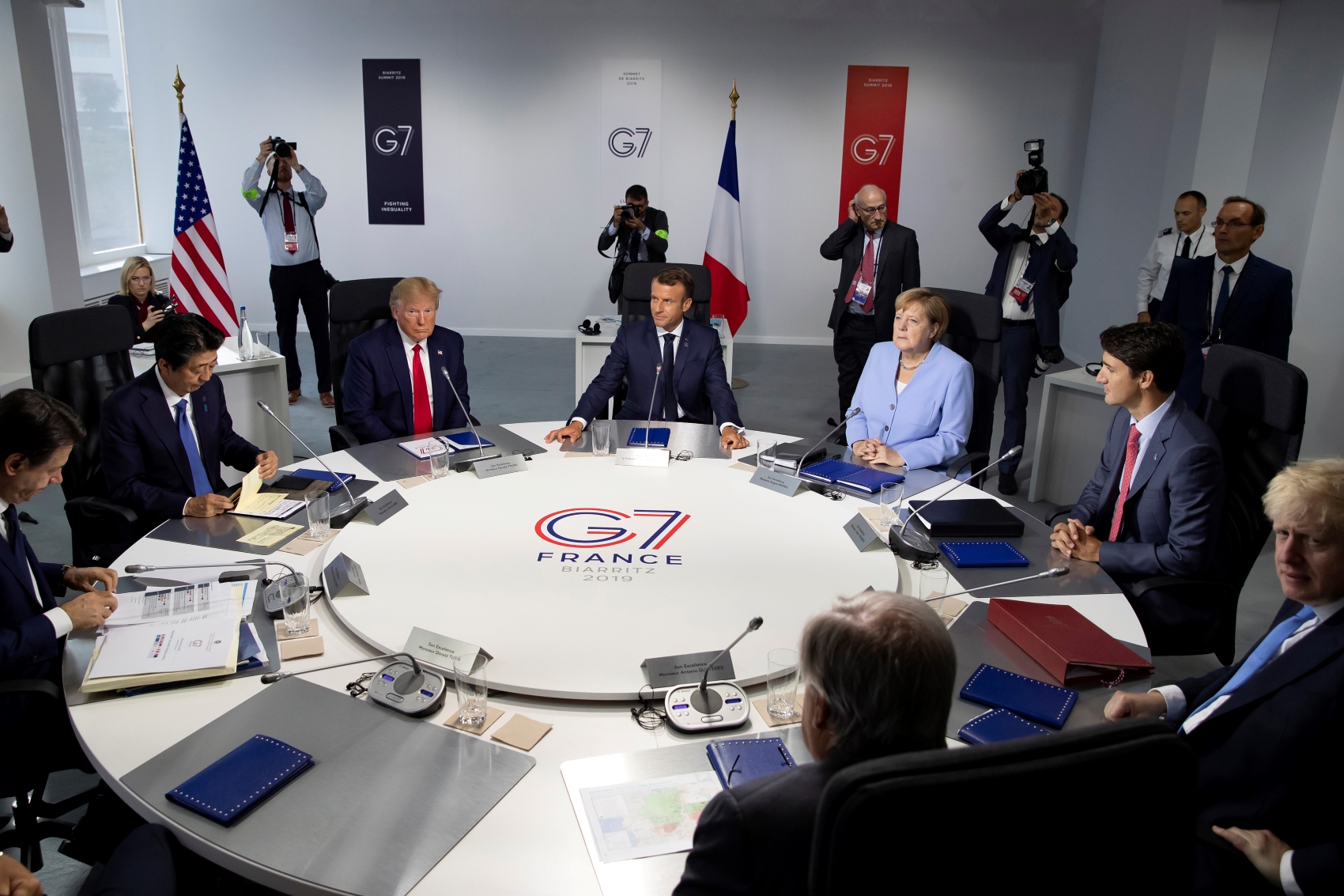From the left, Italian Prime Minister Giuseppe Conte, Japanese Prime Minister Shinzo Abe, U.S President Donald Trump, French President Emmanuel Macron, German Chancellor Angela Merkel, Canadian Prime Minister Justin Trudeau, Britain's Prime Minister Boris Johnson at the G-7 summit in France on Monday Aug. 26 2019. (Ian Langsdon/Pool via AP)