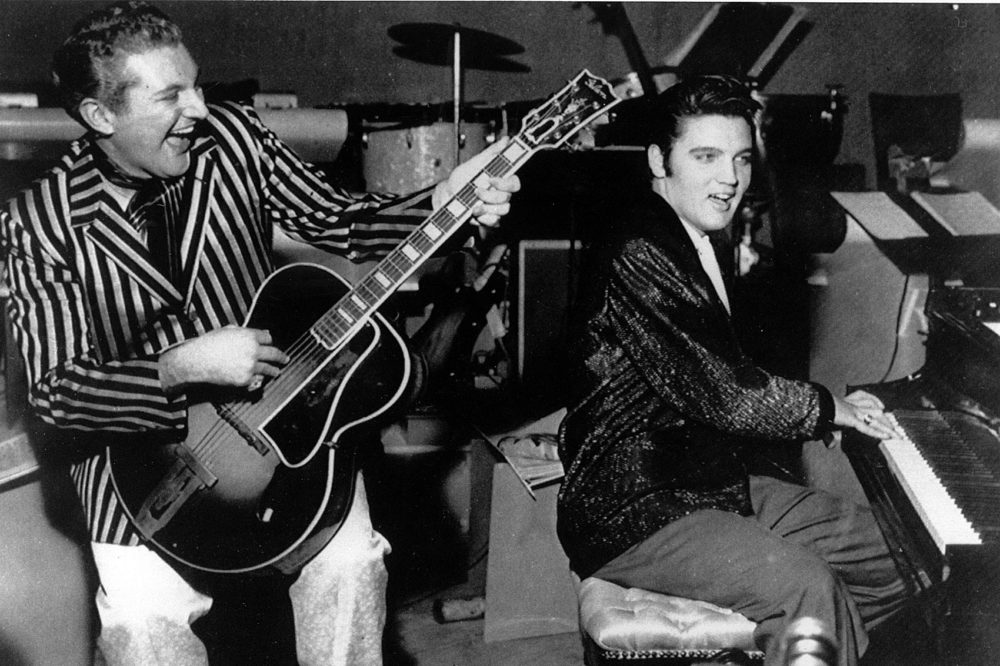Piano virtuoso Liberace is shown playing the guitar with Elvis Presley at the piano in November 1956 at the Riviera Hotel in Las Vegas. (AP Photo)