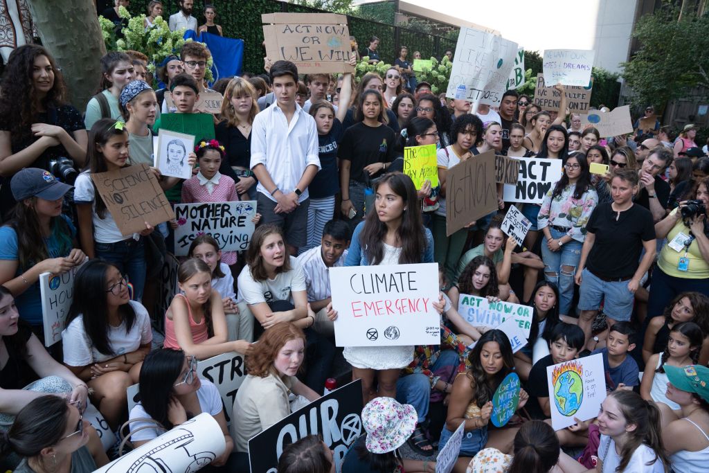 Climate justice activist Xiye Bastida (middle, holding the white "Climate Emergency" sign) strikes outside the U.N. headquarters with Swedish environmental activist Greta Thunberg. Hundreds of other teenagers protested outside the U.N. in New York City. (Bryan R. Smith/AFP/Getty Images)