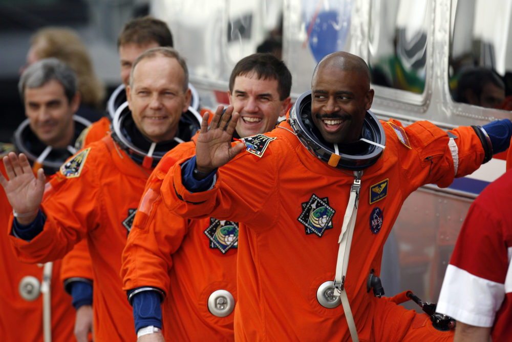 Leland Melvin and Space Shuttle Atlantis crew members board a bus at the check out building of the Kennedy Space Center in early 2008. (Eliot J. Schechter/Getty Images)