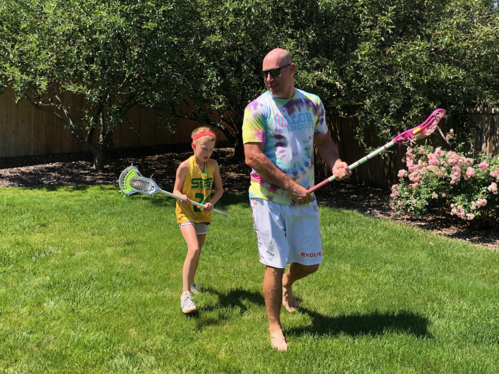 Lacrosse player John Grant Jr. plays with his daugther, Gabby, in their backyard. (Courtesy John Grant Jr.)