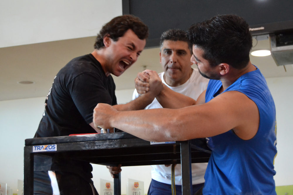 Tomás Silva (left) competes at an arm-wrestling competition in Chile. (Paige Sutherland for WBUR)