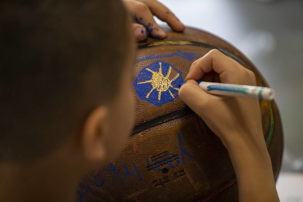 A group of 8 and 9-year-old boys at the Yawkey Boys and Girls Club in Roxbury decorated old basketballs, which were being collected by artist Shaka Dendy to use to create a large scale public sculpture which will be on display at the Boston Center for the Arts Plaza on Tremont St. (Jesse Costa/WBUR)