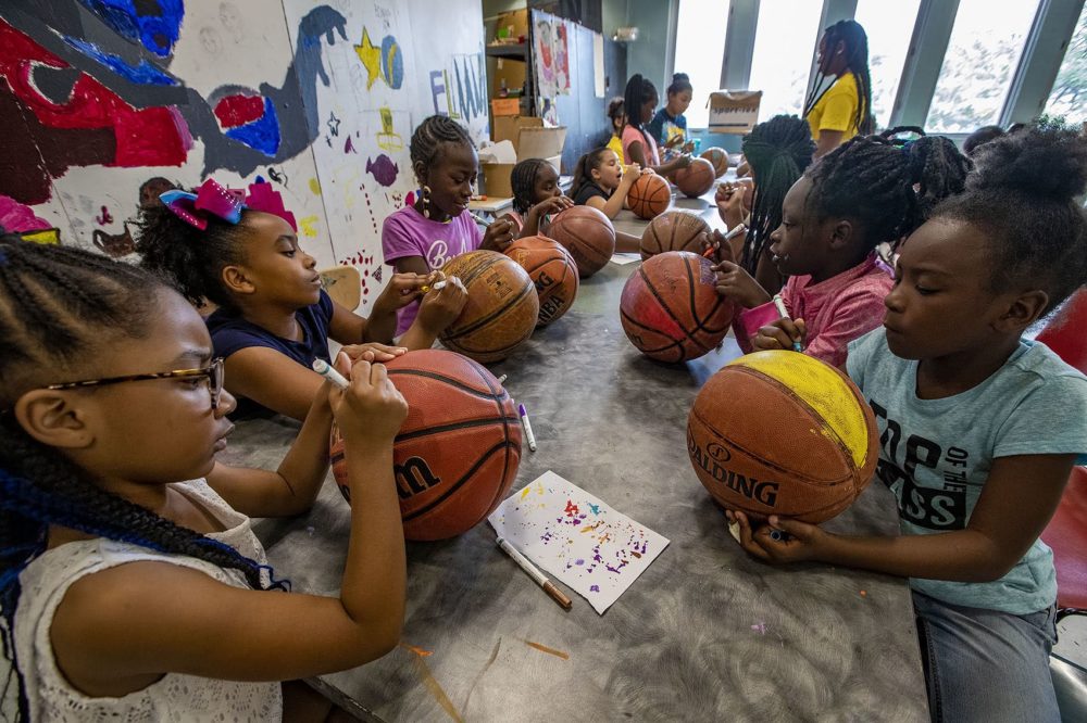 A group of 8-year-old girls at the Yawkey Boys and Girls Club in Roxbury decorated old basketballs, which were being collected by artist Shaka Dendy to use to create a large scale public sculpture which will be on display at the Boston Center for the Arts Plaza on Tremont St. (Jesse Costa/WBUR)