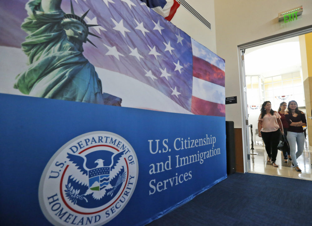 People arrive at the U.S. Citizenship and Immigration Services Miami Field Office in 2018 in Miami. (Wilfredo Lee/AP)