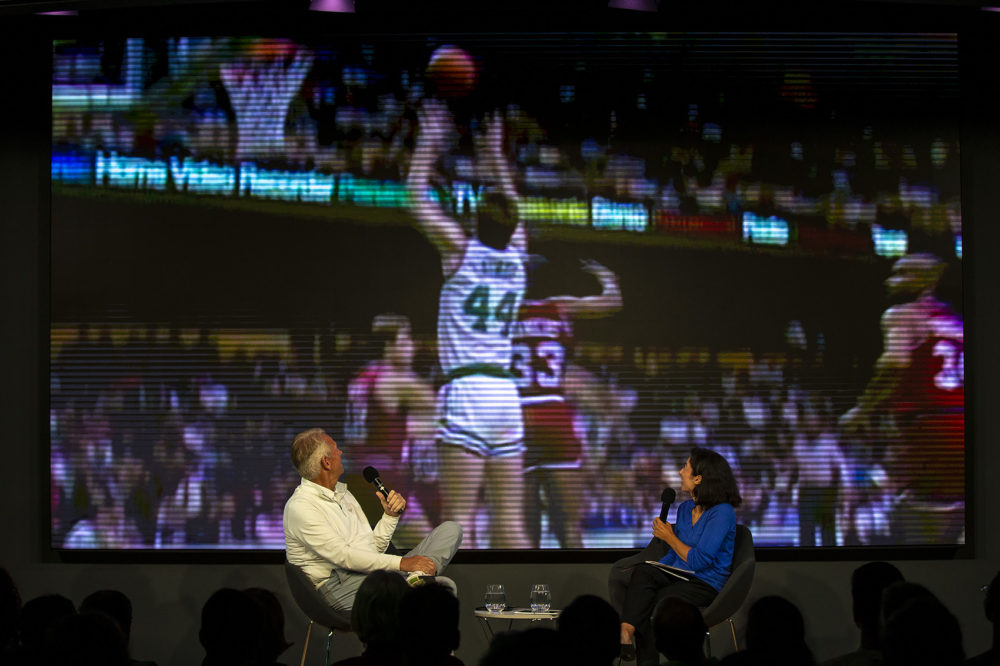 Ainge and WBUR reporter Springer watch a highlight reel of Ainge's playing days in the 1980s. (Jesse Costa/WBUR)