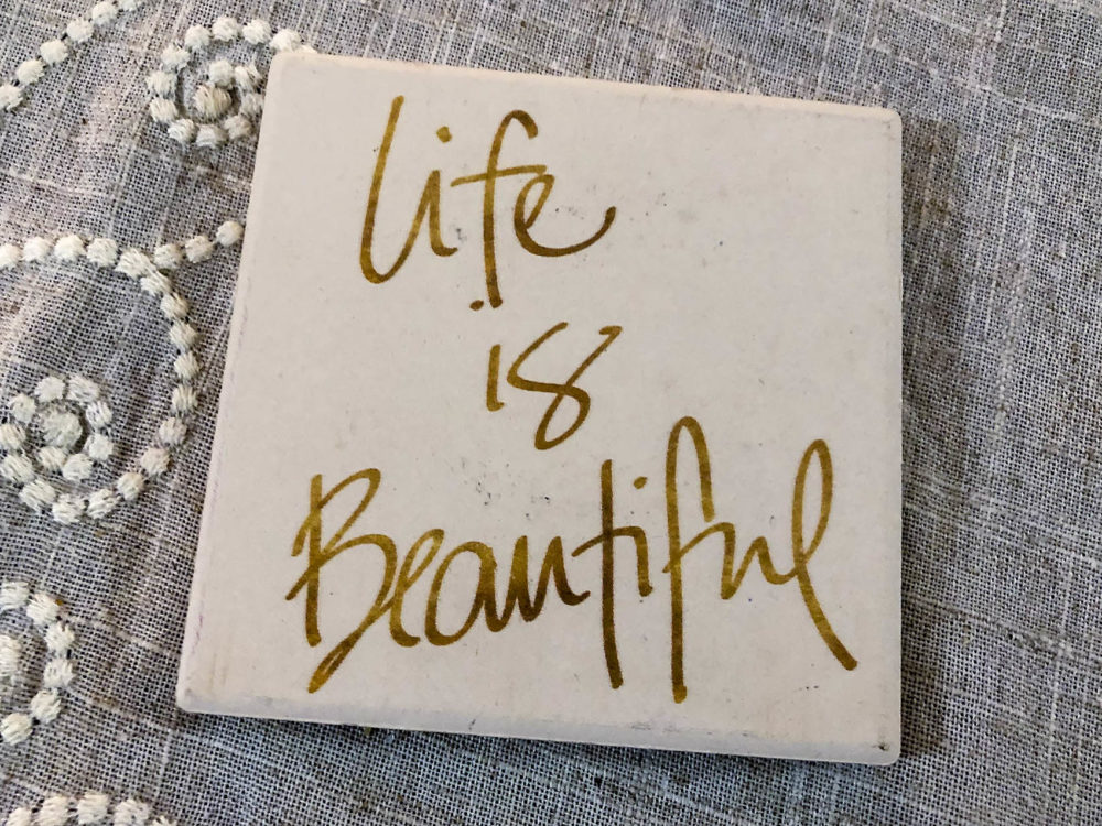 Coasters on the table where the support group meets say “Life is Beautiful” and “Laugh Often.” (Lynn Jolicoeur/WBUR)