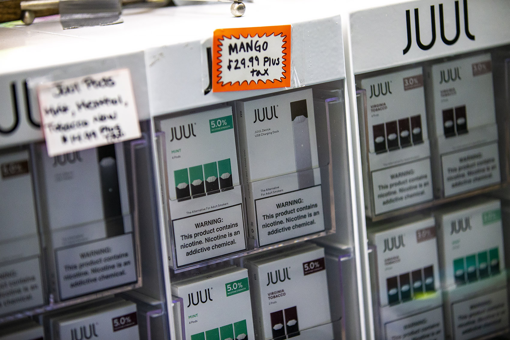 Various Juul products on display at Fast Eddie's Smoke Shop in Allston which will no longer be available after Governor Baker's declaration for a four-month temporary ban on all vaping products. (Jesse Costa/WBUR)