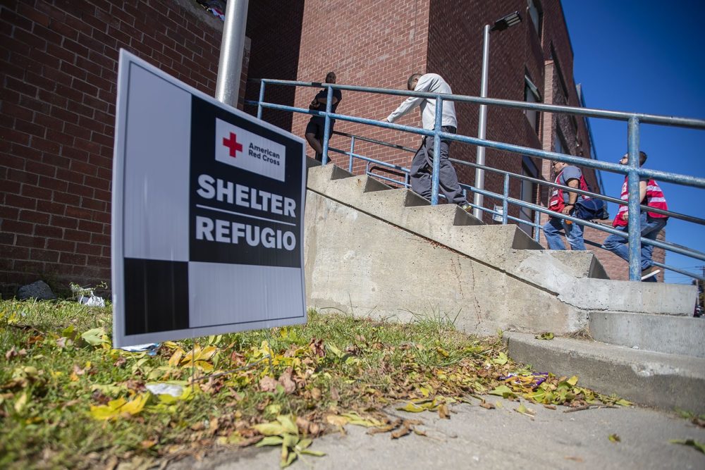 Evacuees enter the shelter set up at Arlington Middle School in Lawrence. (Jesse Costa/WBUR)
