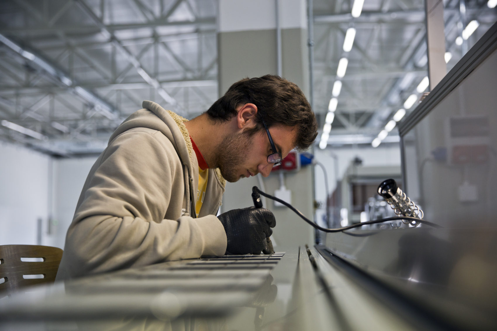 An Employee works on photovoltaic solar modules produced in the village of Slatina on June 8, 2016. (Visar Kryeziu/AP)