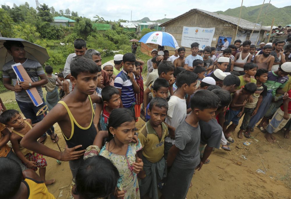 Rohingya refugee children watch Myanmarese and Chinese officials arrive at Nayapara camp in Cox's Bazar, Bangladesh on August 22, 2019. (Mahmud Hossain Opu/AP)