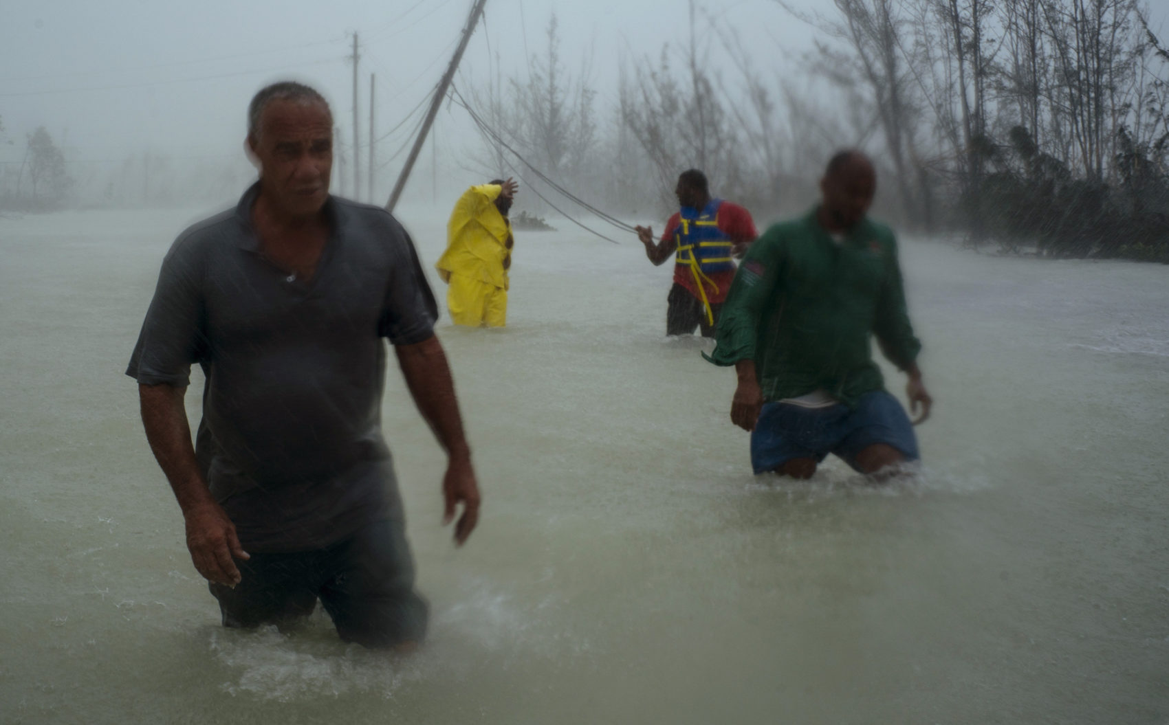 Volunteers wade through a road flooded by Hurricane Dorian as they work to rescue residents near the Causarina bridge in Freeport, Grand Bahama, Bahamas. (Ramon Espinosa/AP)